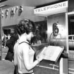 Pay phone Phone Book outside of a Woolworth 1960s POSTER 24 X 18 Inches Wall Art
